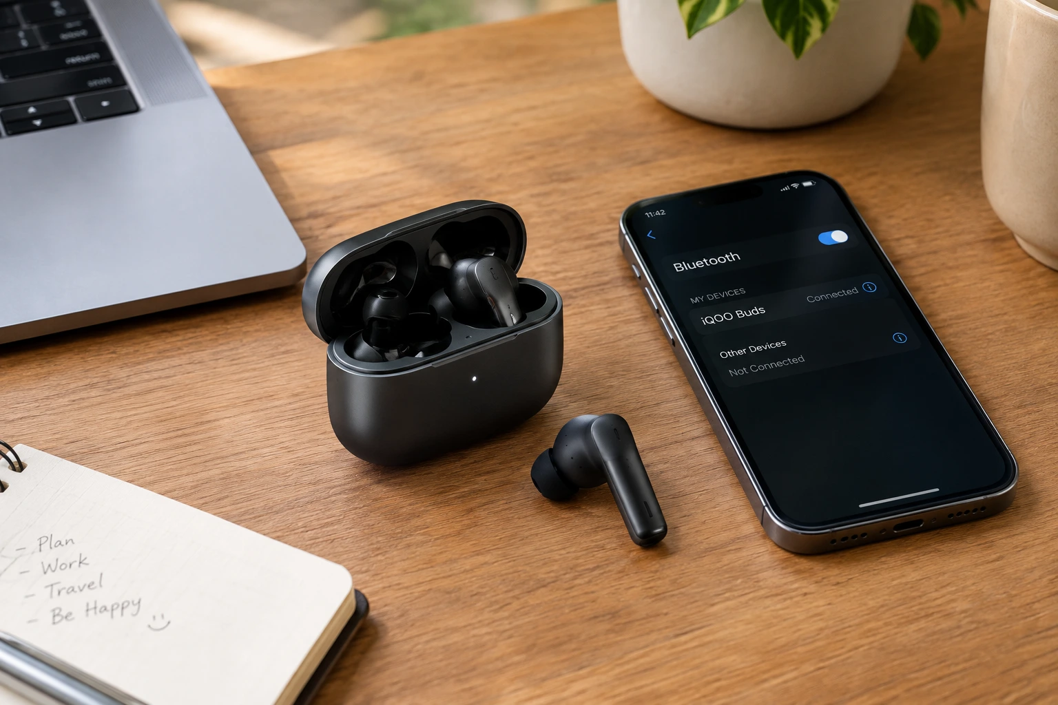 Wireless earbuds and smartphone on a desk
